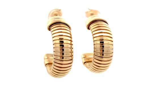 A pair of yellow gold chunky huggie earrings, available at Heller Jewelers.