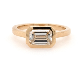 Bezel set emerald cut diamond horizontally set by Heller Jewelers