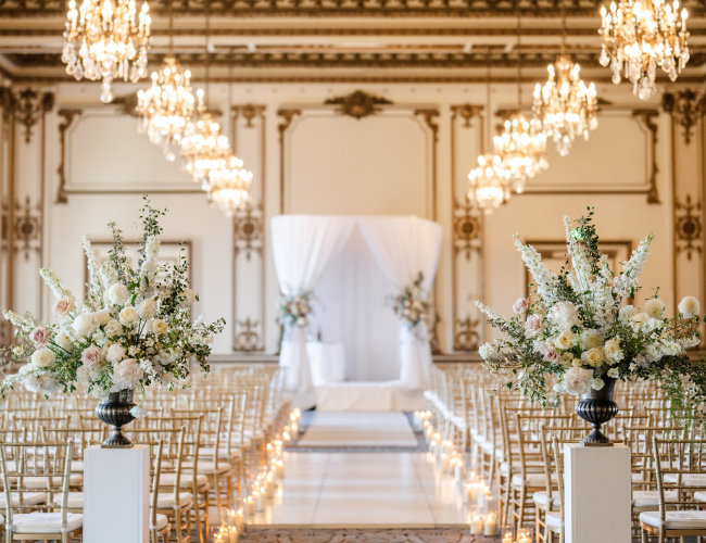 A wide shot of an elegantly decorated wedding ceremony area before guests arrive.