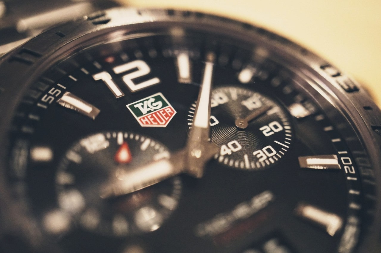 A close-up of a TAG Heuer sports watch with tachymeter complications.