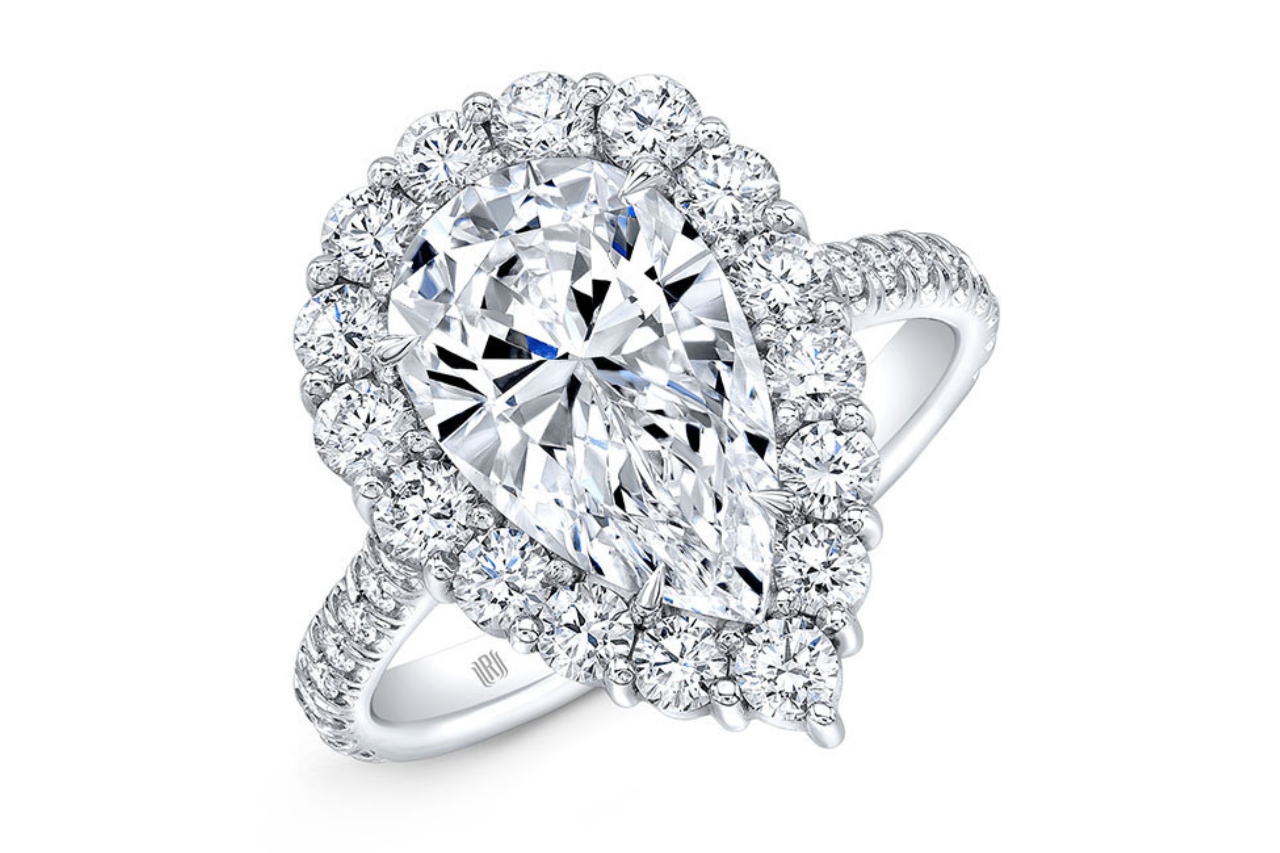 an impressive pear shaped halo engagement ring with diamonds along the band as well