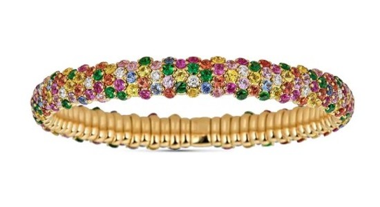 a yellow gold bangle bracelet with multicolored gemstones