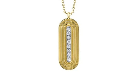 a yellow gold statement pendant with diamond accents