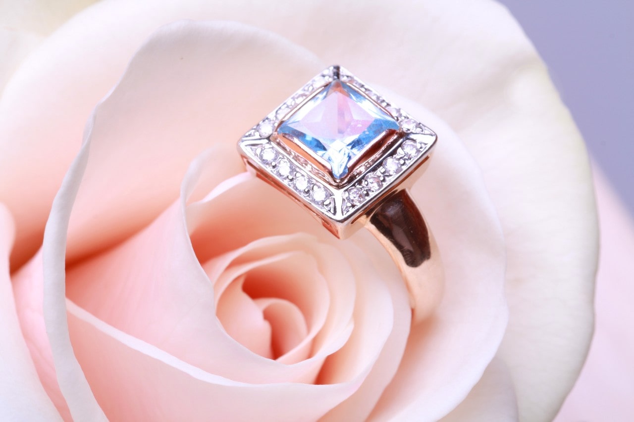 halo engagement ring with princess cut center stone