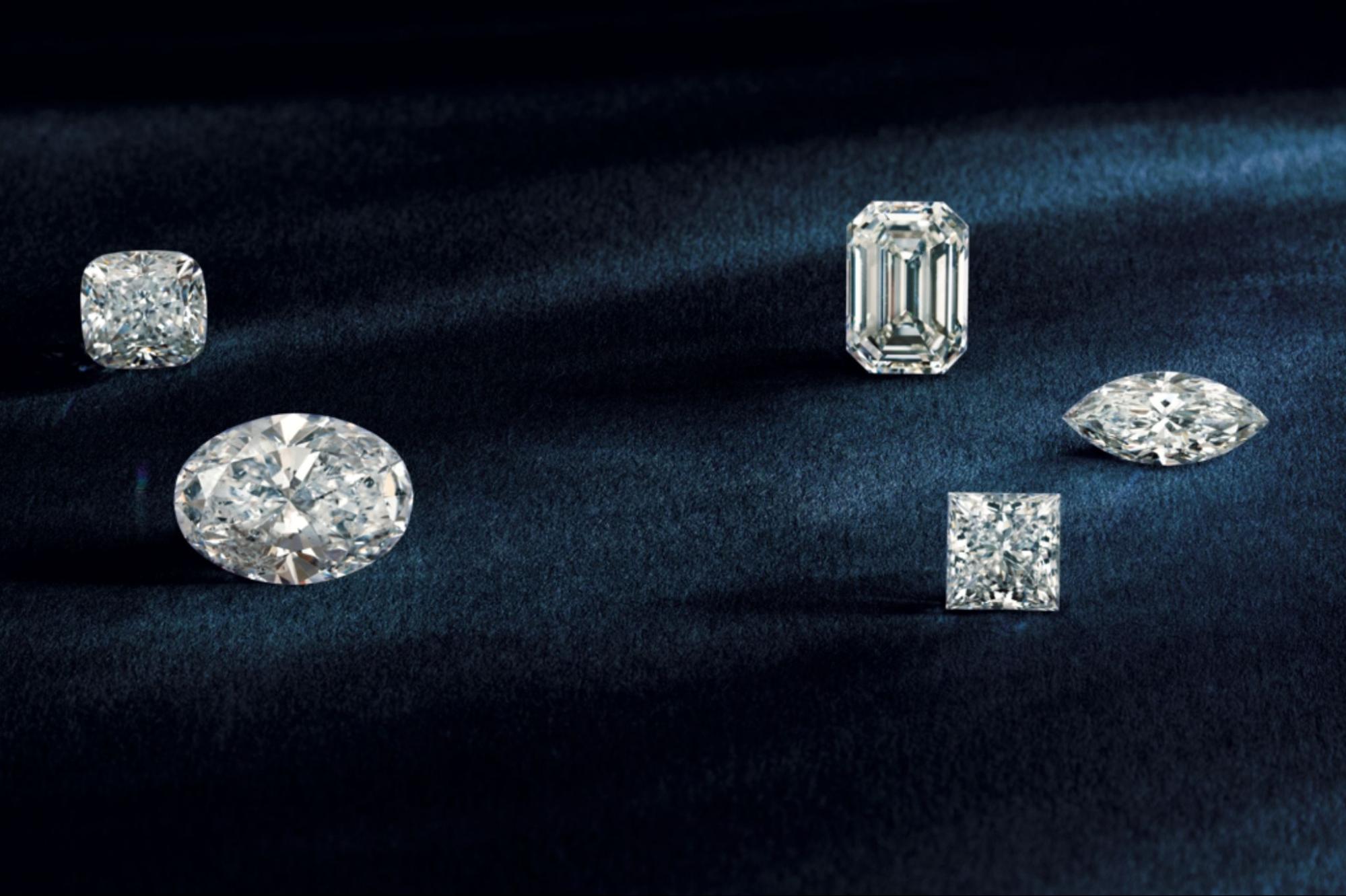 A close-up of two round-cut diamonds atop small diamond cuttings.